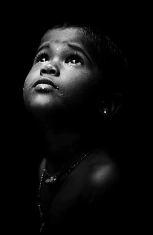 Black-and-white portrait of a child looking upward