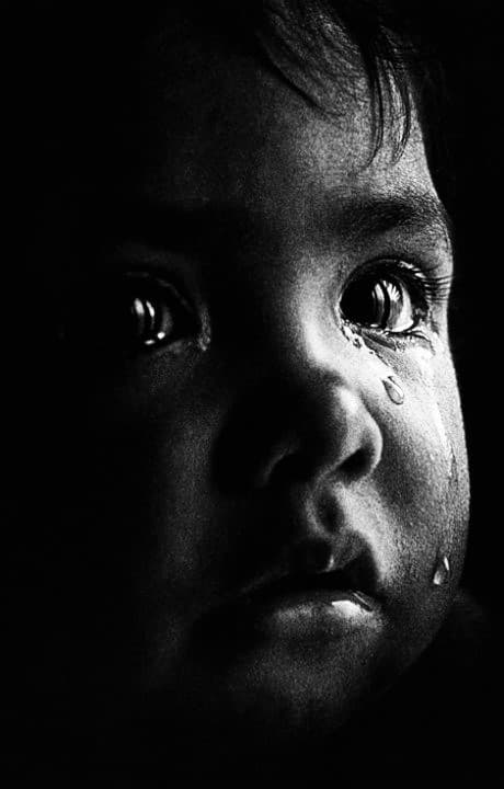Black-and-white portrait of a crying infant